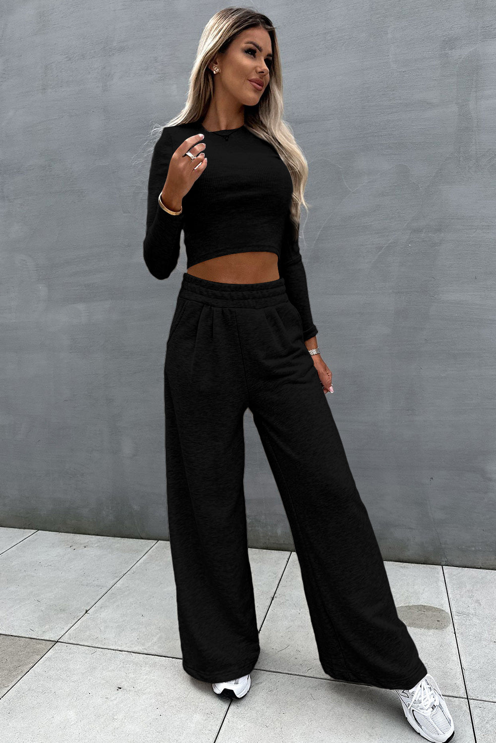 Two-piece set consisting of a black crop top and wide-leg trousers