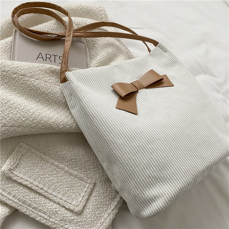 Stylish and elegant women's bag, adorned with a contrasting bow.