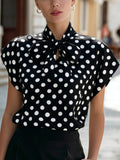 Polka dot top with a bow collar and short sleeves