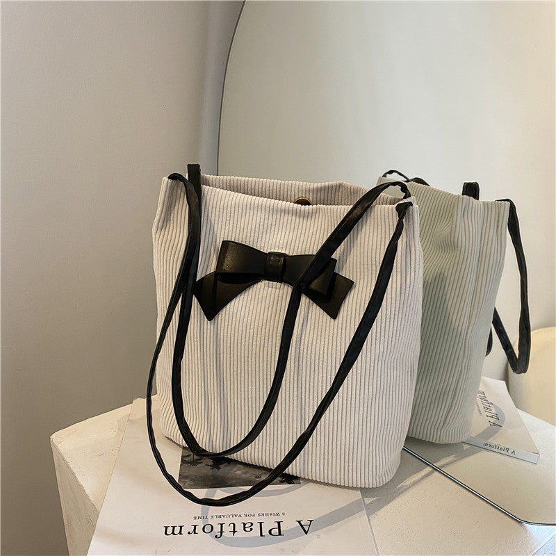 Stylish and elegant women's bag, adorned with a contrasting bow.