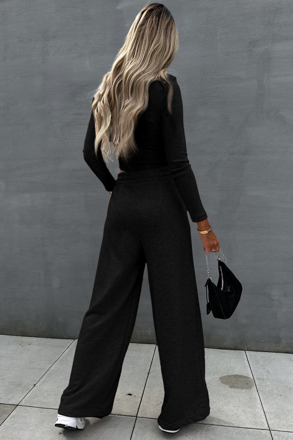 Two-piece set consisting of a black crop top and wide-leg trousers